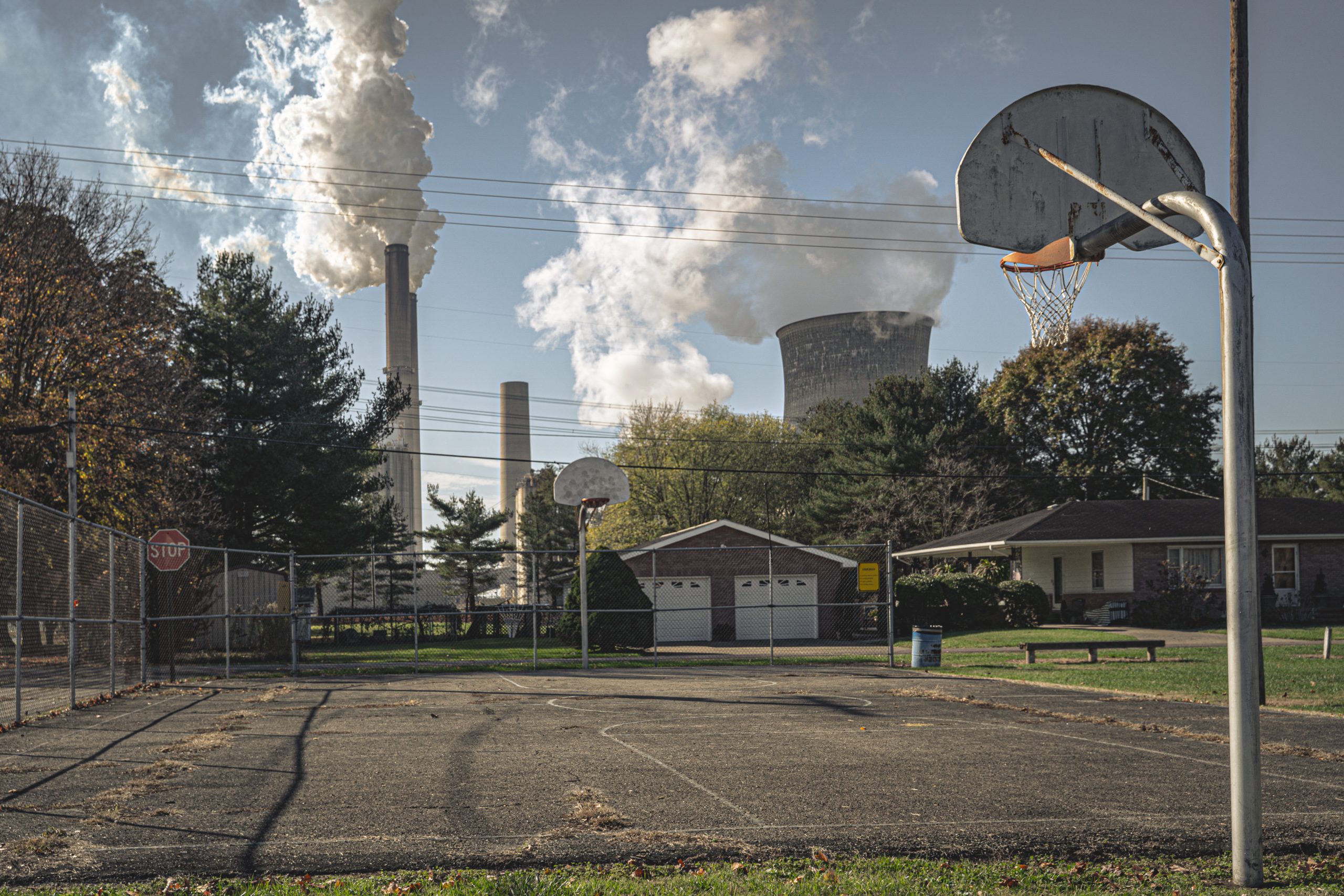 Cooling towers behind a suburban basketball court, Ohio River
